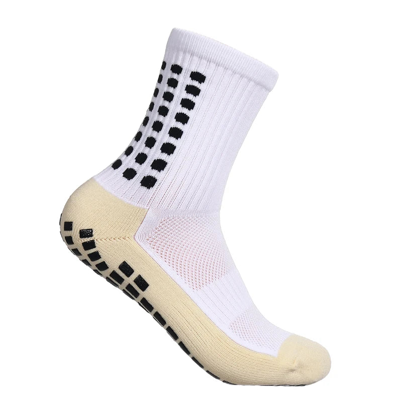 A pair of athletic grip socks with non-slip rubber grip sole, designed for running and high-performance activities. The socks are mid-calf length with a geometric pattern in black, white, and gray.